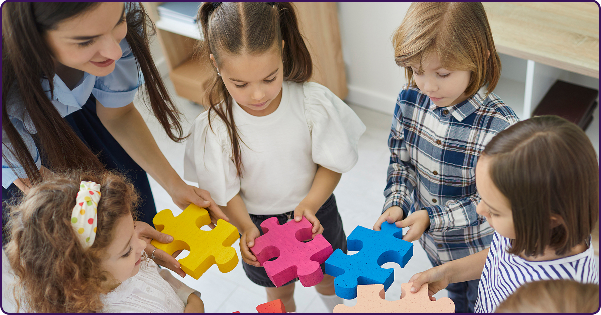 teacher working with elementary children in classroom